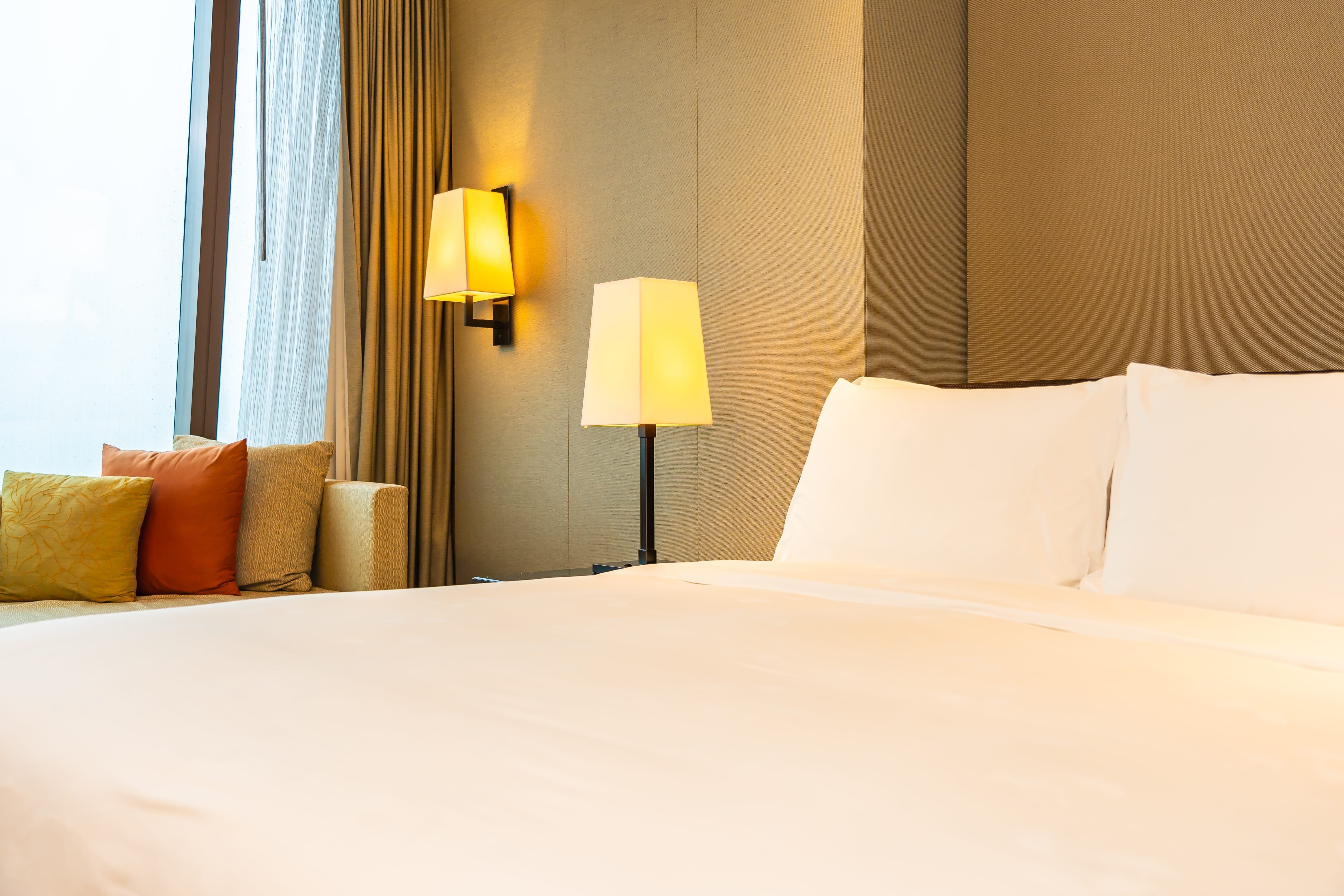 white comfortable pillow blanket bed with light lamp - White comfortable pillow and blanket on bed with light lamp